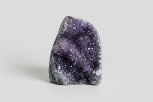 Amethist geode cutbase Š paarse kristallen binnenkant op natuurlijke ondergrond